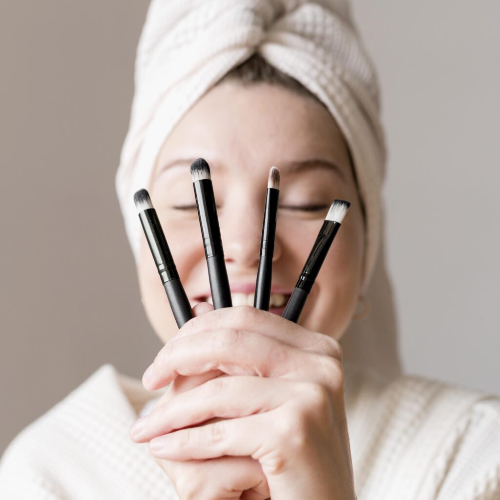 happy-woman-with-make-up-brushes